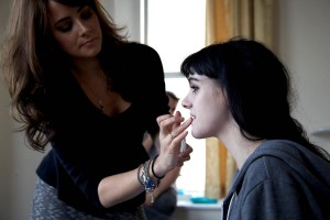 Alicia on set applying makeup
